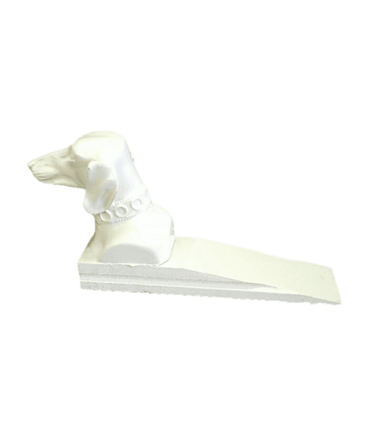 White dog-shaped door stopper on a black background