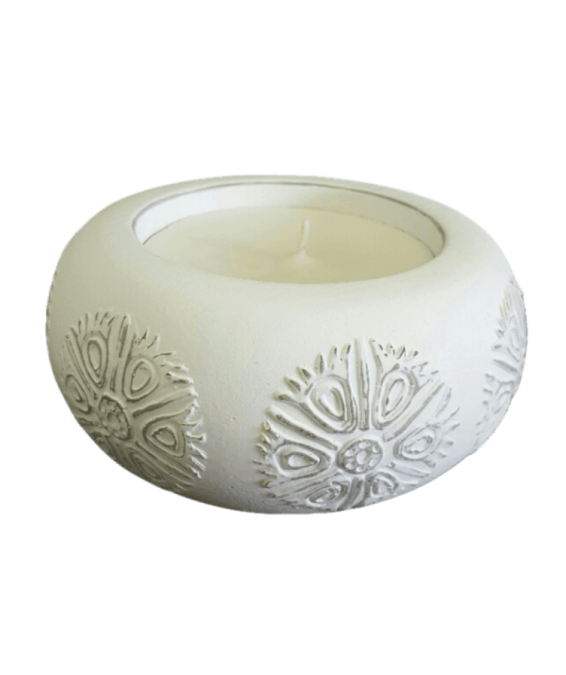 White textured candle holder with a candle inside on a black background