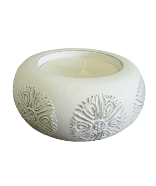 White textured candle holder with a candle inside on a black background