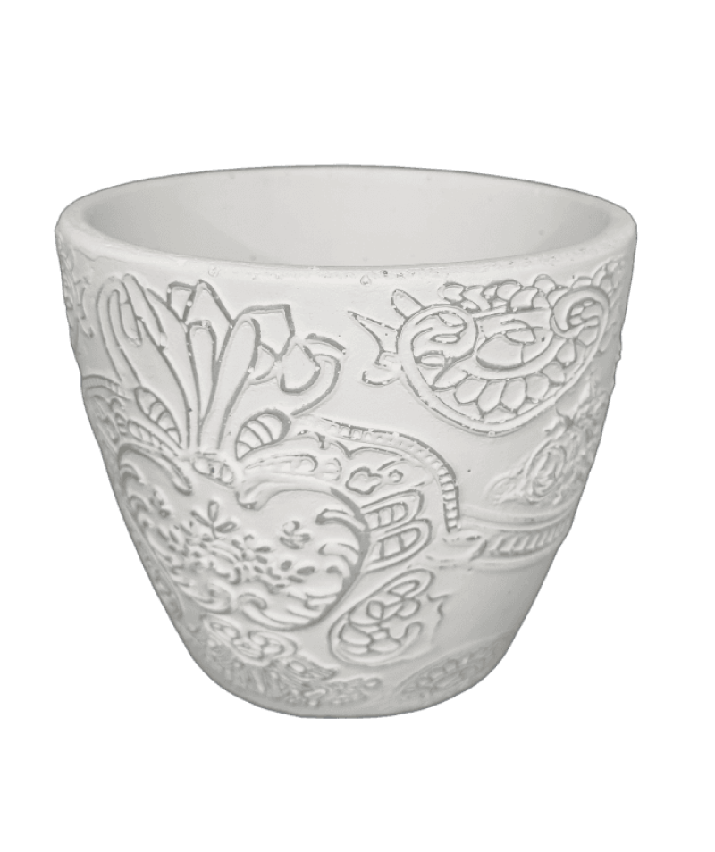 White ceramic cup with intricate paisley patterns on a black background