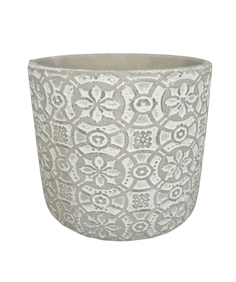 Decorative white planter with intricate patterns on a black background