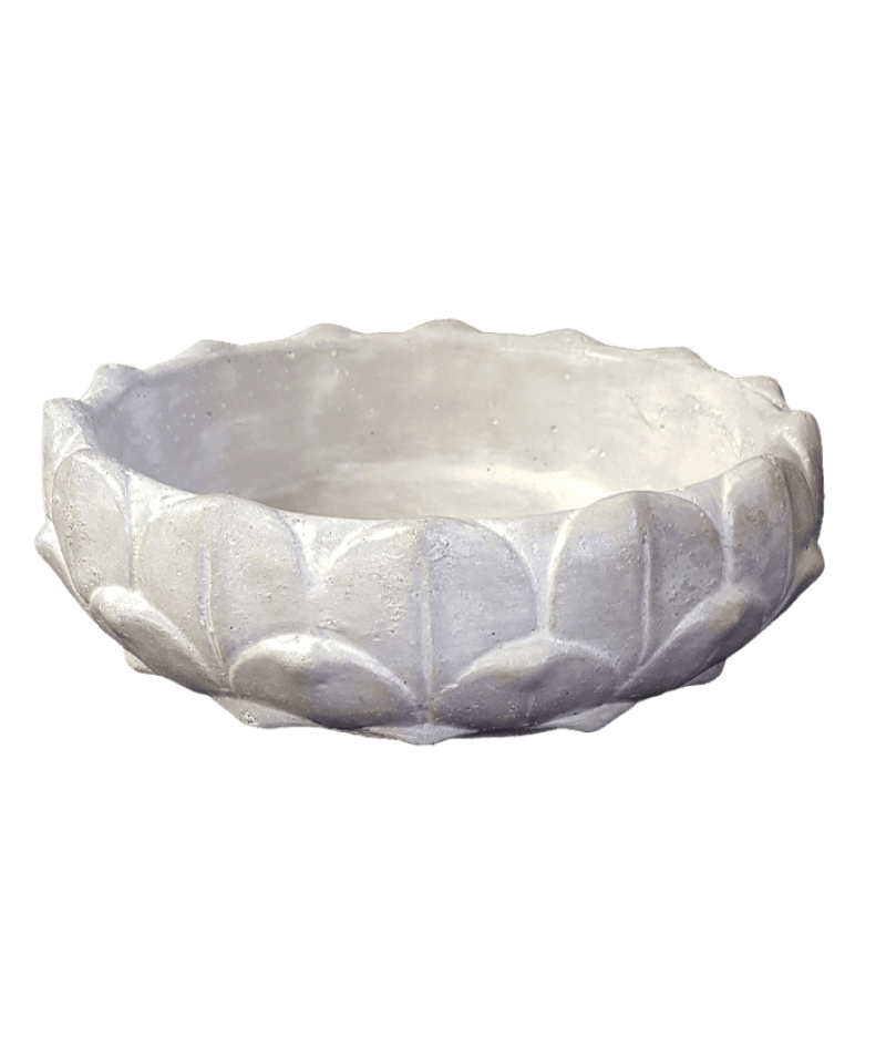 White stone bowl with lotus flower pattern on a black background