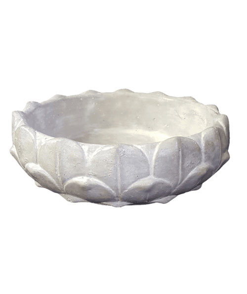 White stone bowl with lotus flower pattern on a black background